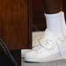 Michigan captain and senior quarterback Denard Robinson shows off his trademark untied shoelaces as he stands at a podium during a press conference at the Junge Family Champions Center on Monday afternoon. Melanie Maxwell I AnnArbor.com